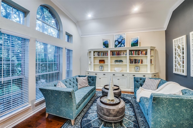 living room featuring dark wood-type flooring, ornamental molding, and vaulted ceiling