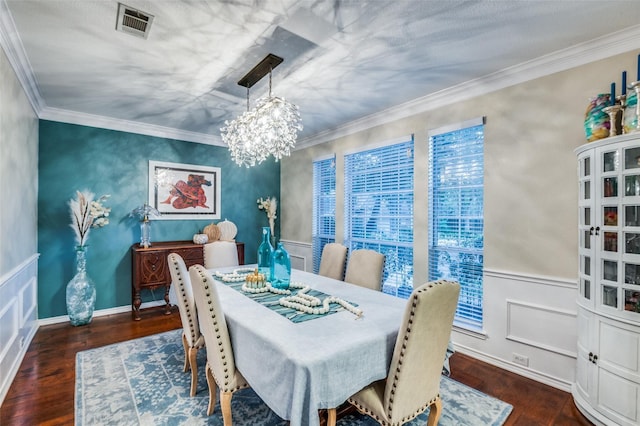 dining space featuring crown molding, a notable chandelier, and dark hardwood / wood-style flooring