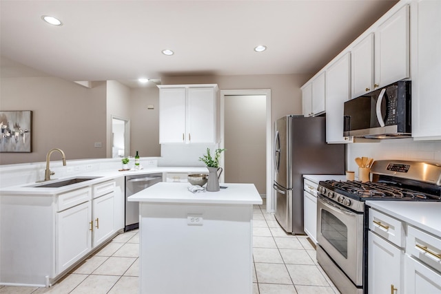 kitchen with light tile patterned flooring, appliances with stainless steel finishes, a center island, and sink