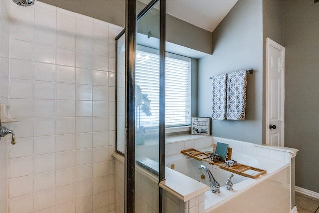 bathroom featuring tile patterned flooring and shower with separate bathtub