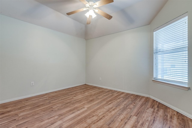 empty room featuring ceiling fan, lofted ceiling, and light wood-type flooring