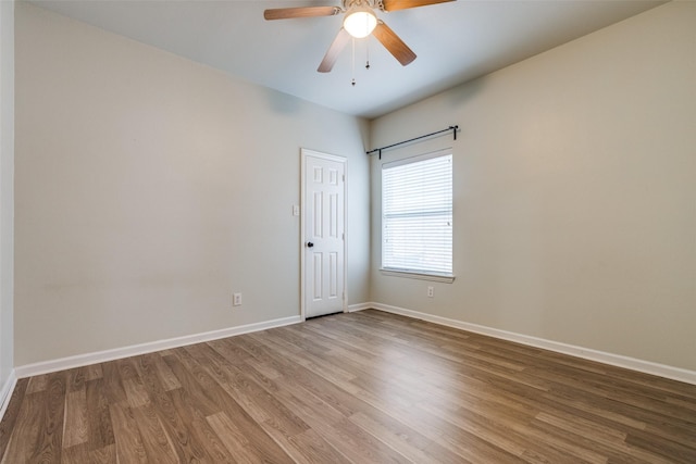 unfurnished room with ceiling fan and wood-type flooring