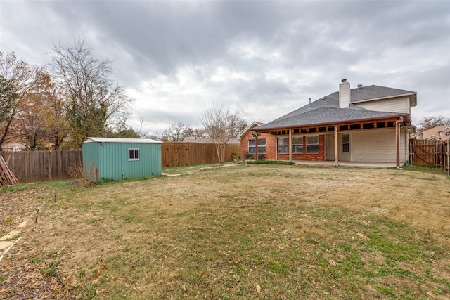 view of yard featuring a patio area and a storage shed