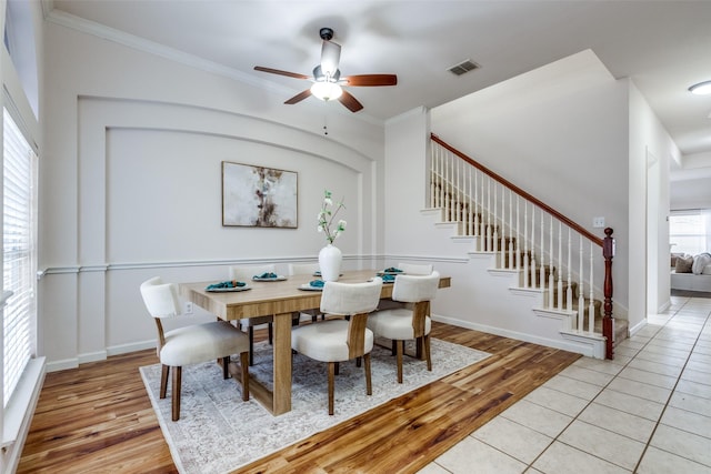 dining space with light wood-type flooring, ceiling fan, and crown molding