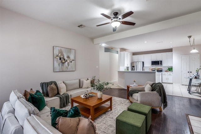 living room featuring ceiling fan and light wood-type flooring