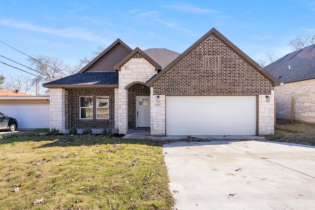 view of front of home with a front lawn and a garage