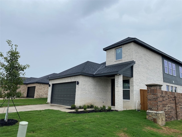 view of front of house featuring a garage and a front lawn