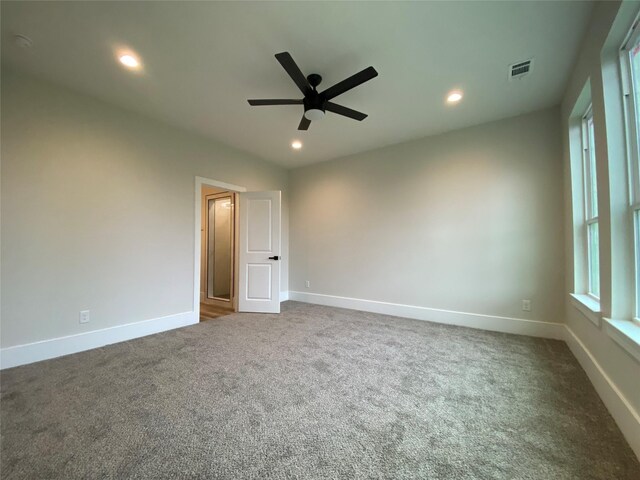 carpeted empty room featuring ceiling fan