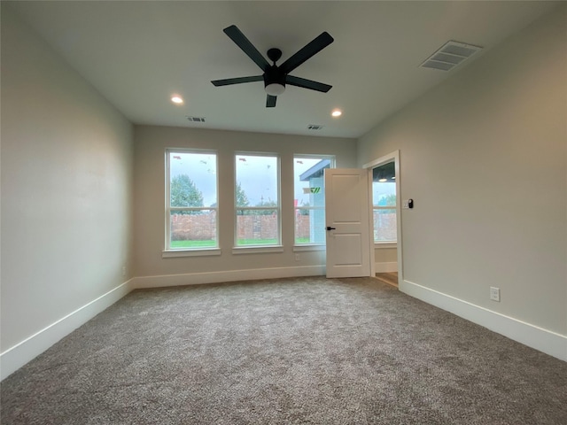 carpeted empty room featuring ceiling fan