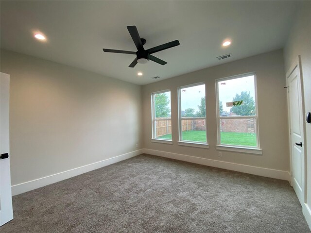 empty room featuring carpet floors and ceiling fan