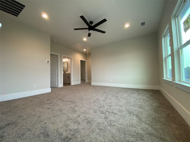 unfurnished bedroom featuring ceiling fan, carpet flooring, and ensuite bath