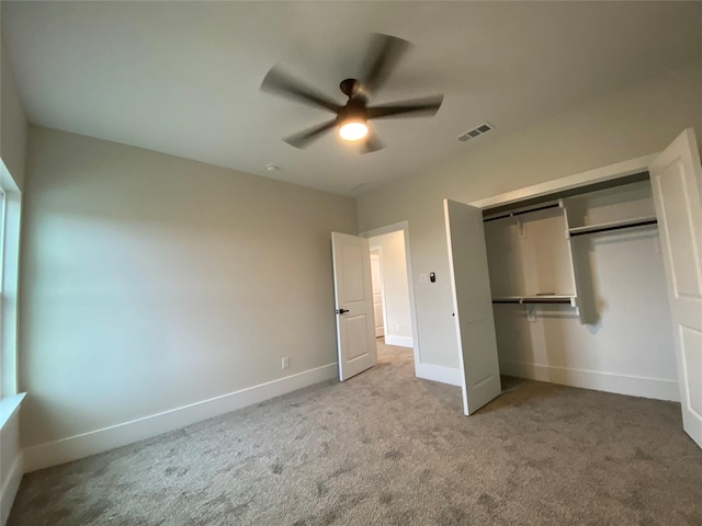 unfurnished bedroom featuring carpet floors, ceiling fan, and a closet