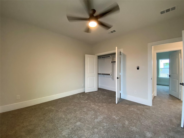 unfurnished bedroom with a closet, ceiling fan, and dark colored carpet