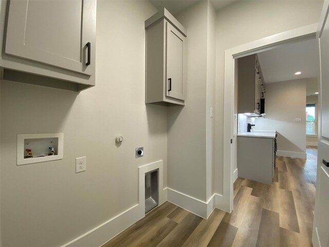 laundry room with cabinets, hookup for a washing machine, dark hardwood / wood-style floors, and hookup for an electric dryer