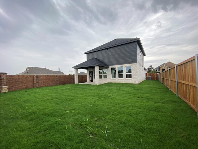 rear view of house with a lawn