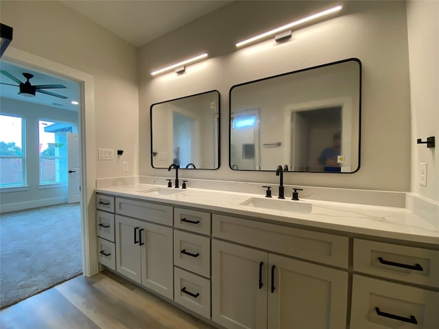 bathroom with ceiling fan and vanity