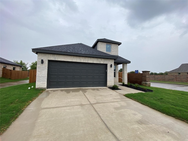 view of front of house with a garage and a front lawn