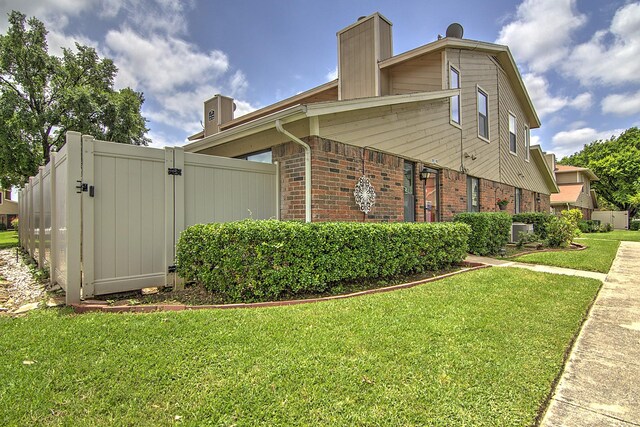 view of side of home featuring a yard