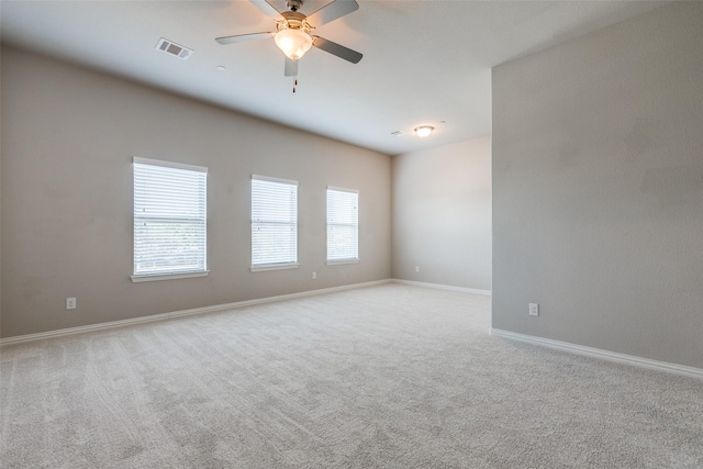 empty room featuring ceiling fan and light colored carpet