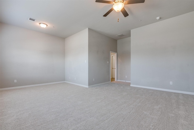 spare room featuring ceiling fan and light colored carpet