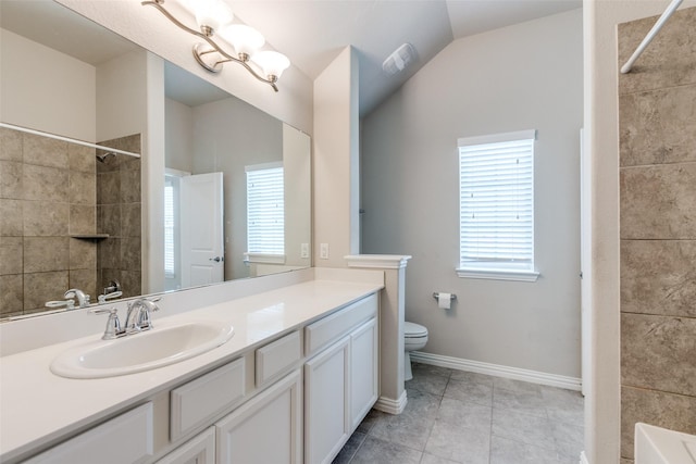 bathroom with tile patterned flooring, vanity, toilet, and lofted ceiling