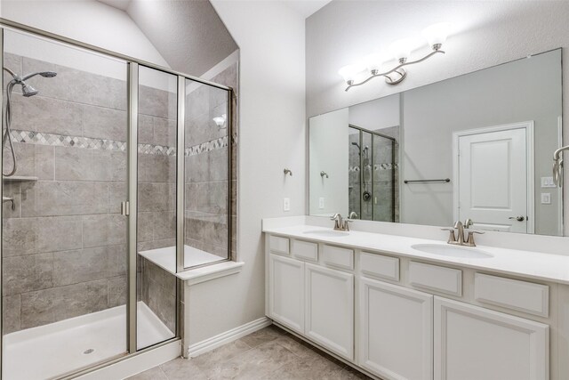 bathroom with a shower with door and vanity