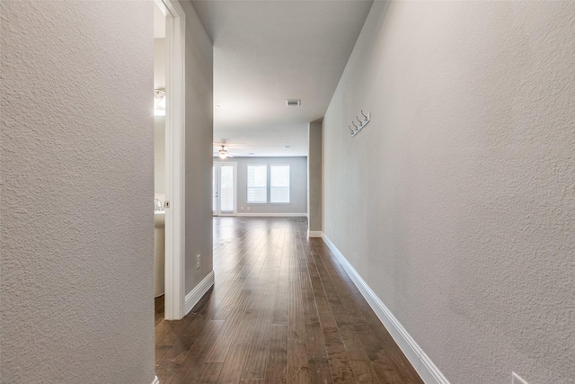 corridor with dark wood-type flooring