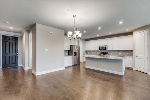 living room featuring hardwood / wood-style flooring and ceiling fan with notable chandelier