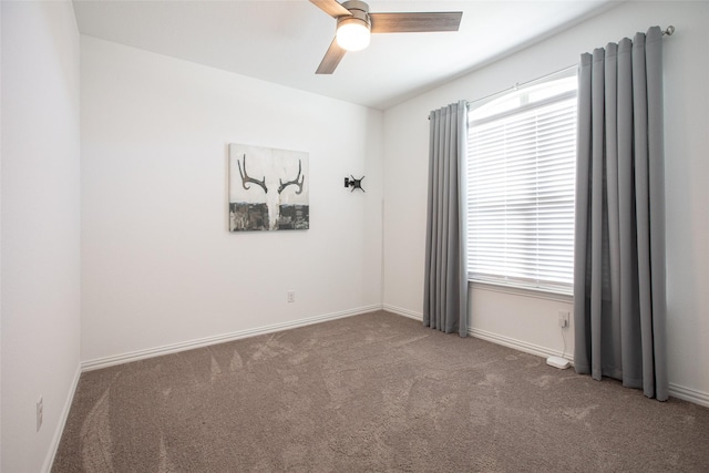 spare room featuring plenty of natural light, carpet floors, and ceiling fan