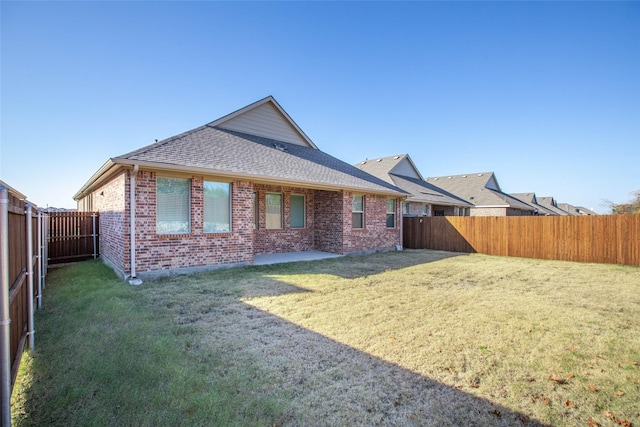 rear view of house featuring a lawn