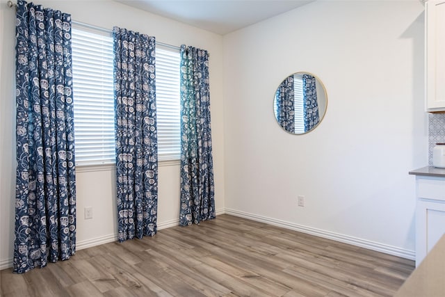 unfurnished dining area with a healthy amount of sunlight and light wood-type flooring