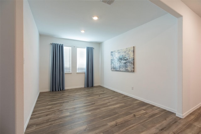 empty room with dark hardwood / wood-style flooring