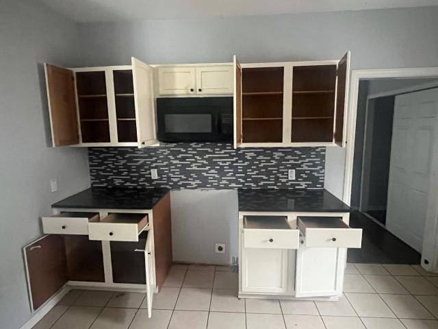 kitchen featuring light tile patterned floors and backsplash