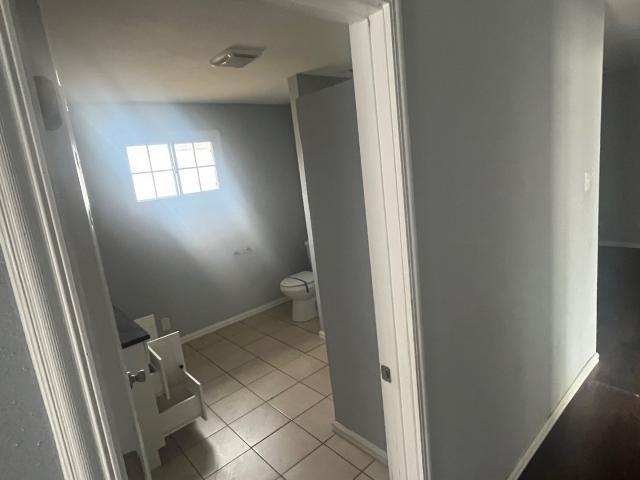 bathroom featuring tile patterned flooring and toilet