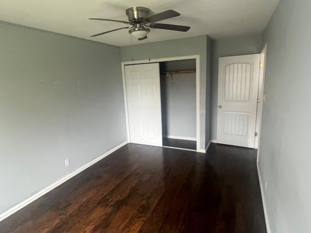 unfurnished bedroom featuring ceiling fan, a closet, and dark hardwood / wood-style floors