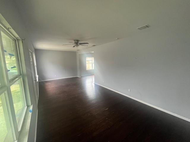 spare room featuring ceiling fan and dark hardwood / wood-style floors