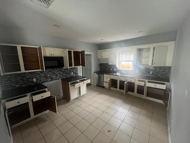 kitchen featuring dishwasher and light tile patterned flooring