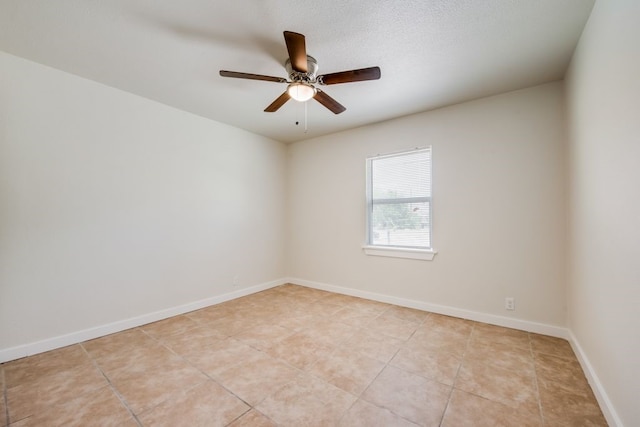 tiled empty room with ceiling fan