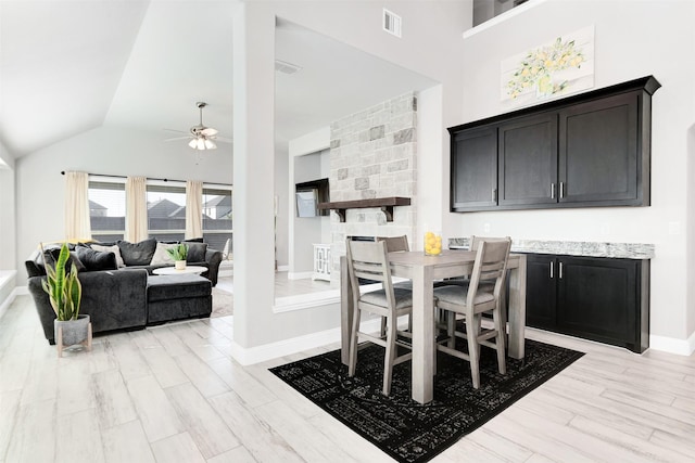 dining space featuring vaulted ceiling, light hardwood / wood-style flooring, and ceiling fan