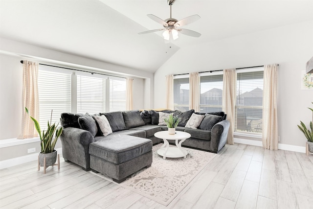 living room featuring ceiling fan, lofted ceiling, and light wood-type flooring