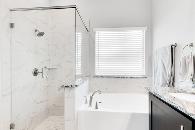 bathroom with vanity and separate shower and tub