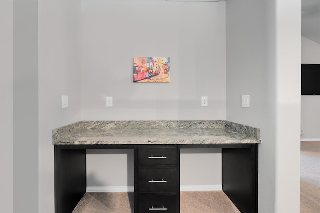 interior space featuring carpet flooring and built in desk