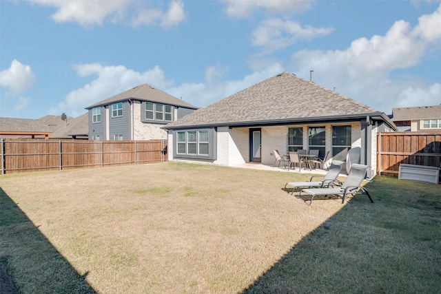 rear view of house featuring a lawn and a patio area