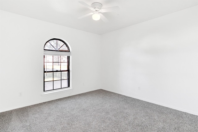 empty room featuring carpet floors and ceiling fan