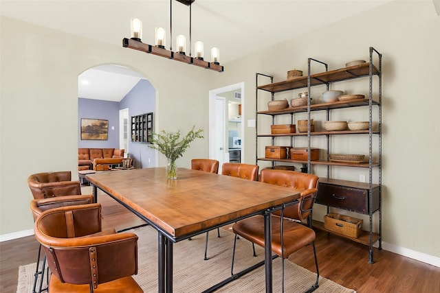 dining space with dark hardwood / wood-style flooring