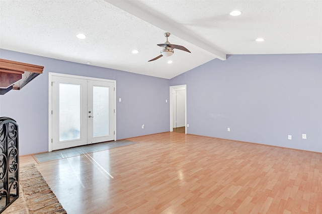 unfurnished living room featuring light wood-type flooring, french doors, lofted ceiling with beams, and ceiling fan