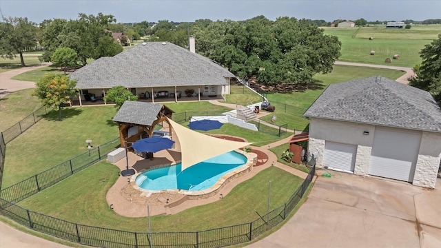 view of pool with a yard