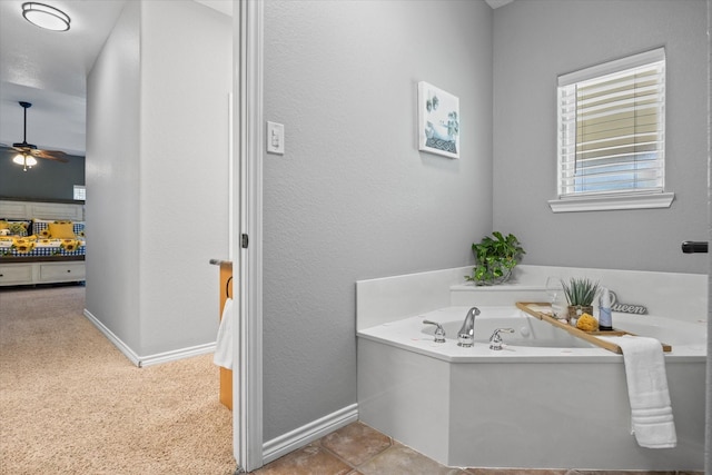 bathroom featuring tile patterned flooring, ceiling fan, and a tub