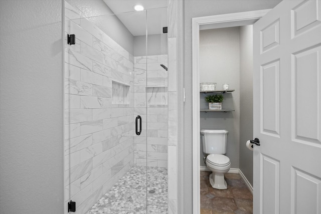 bathroom featuring toilet and walk in shower