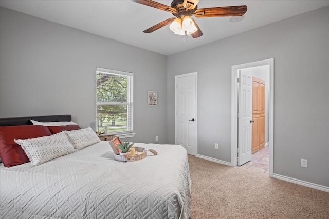 carpeted bedroom featuring ceiling fan and connected bathroom